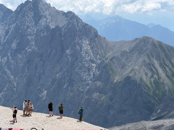 Summit gathering in the Bavarian Alps, blue flag flying