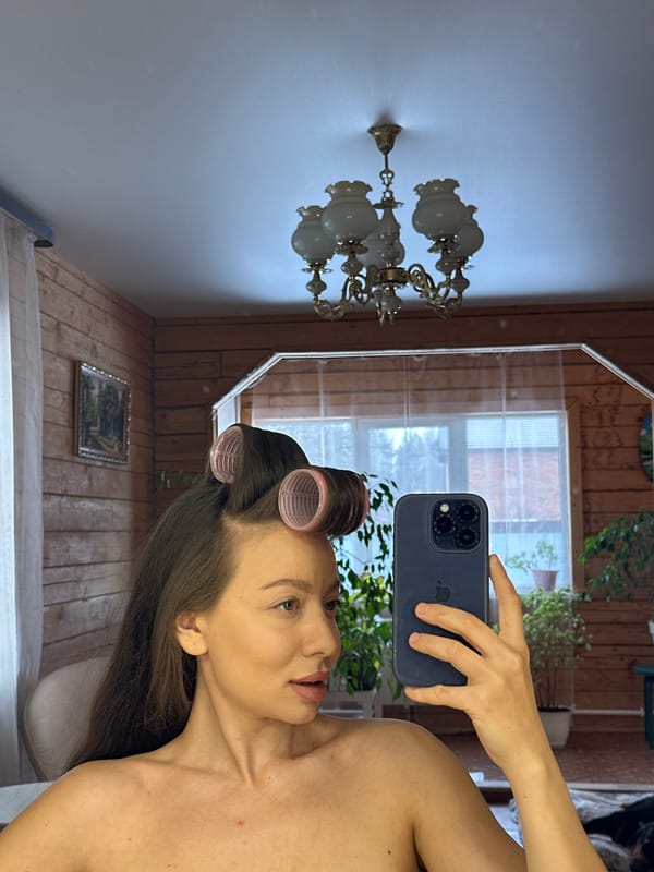 Woman documents morning routine with mirror selfies, pets at home
