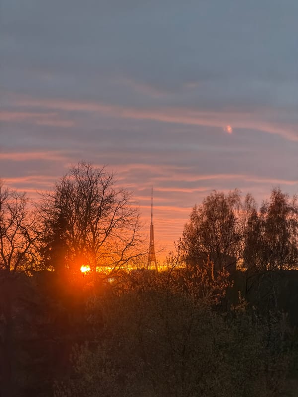 Sunset captured over Riga with radio tower silhouette