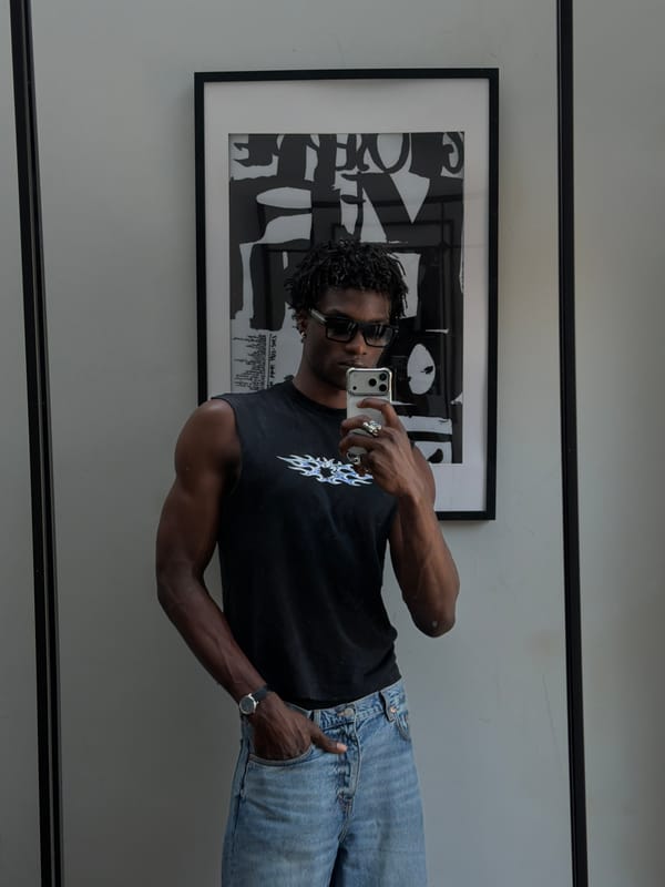 Mirror selfie showing flame graphic tee and light blue denim