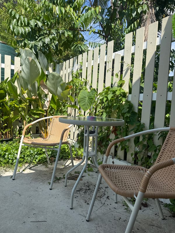 Person rests in outdoor seating area in Choeng Thale