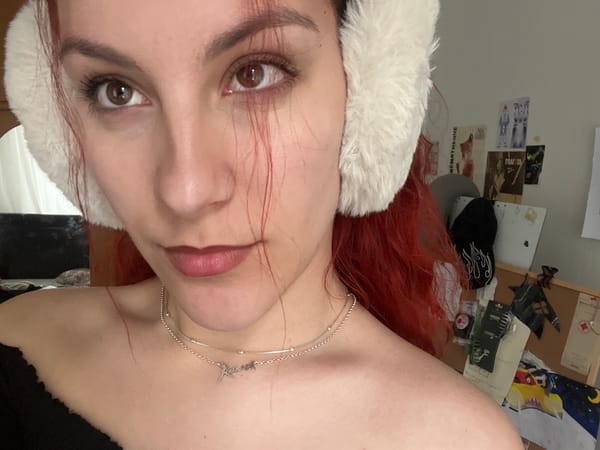 Woman takes selfies wearing white earmuffs in Sofia