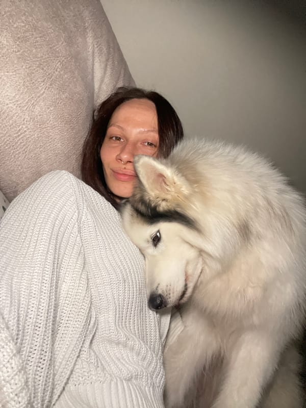 Woman and large white dog rest together in Izhevsk