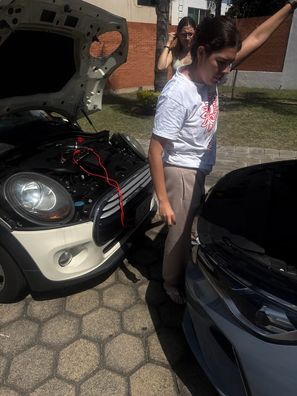 Women jump-start Mini Cooper in Puebla, Mexico