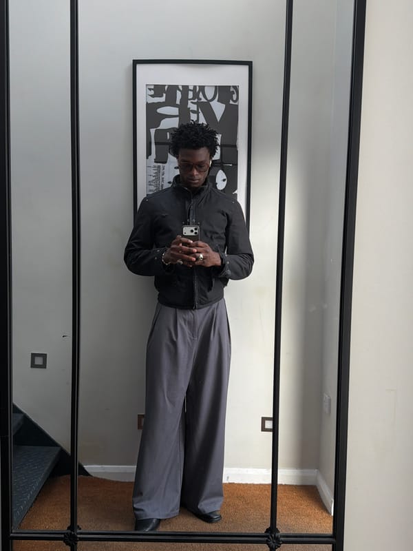 Man takes selfies near mirror and artwork in London