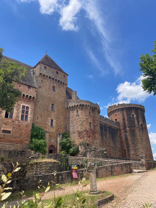 Medieval castle and rural hillside on a sunny afternoon