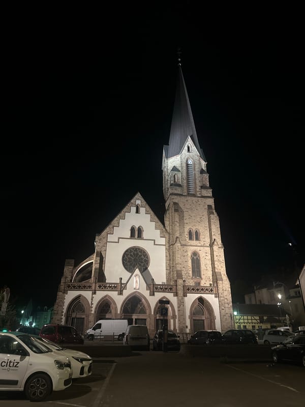 Église Saint Laurent illuminated at night in Bischheim