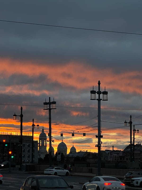 Saint Petersburg street glows under a dramatic summer sunset