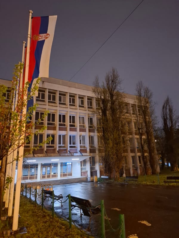 Serbian flag waves at dusk in Novi Sad