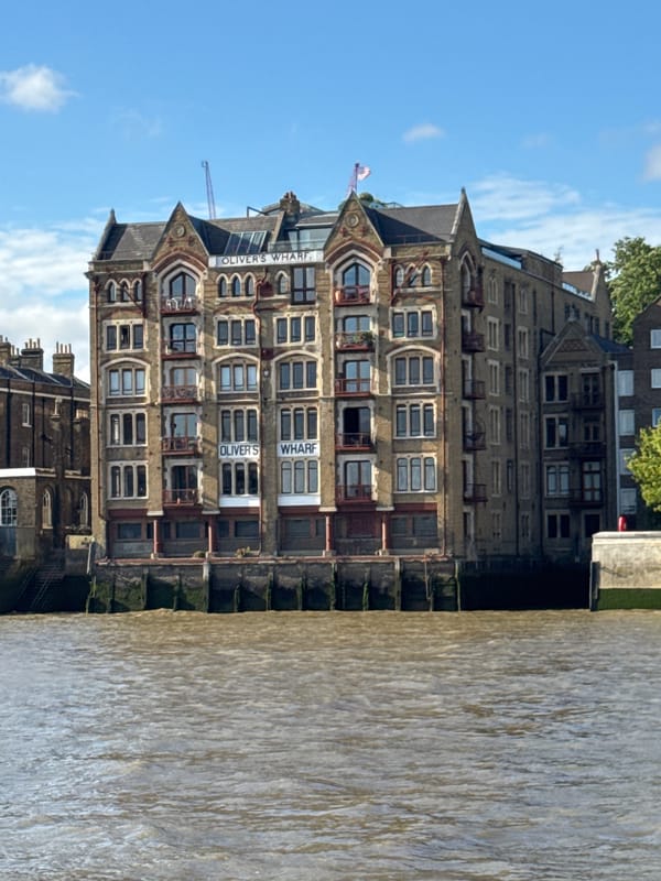 Afternoon boat ride past Oliver's Wharf with Tower Bridge ahead