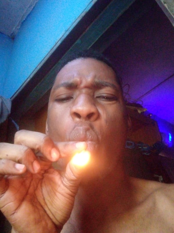 Person smoking indoors captured in photos in Ikorodu