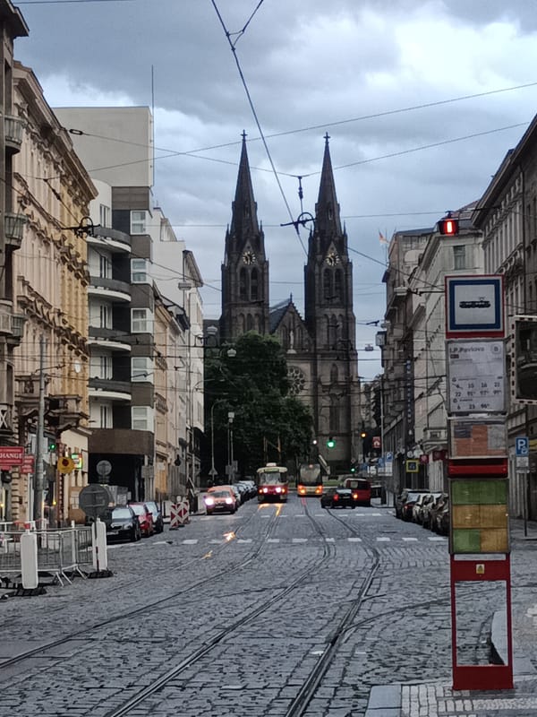 Red tram and Gothic spires on a Prague street