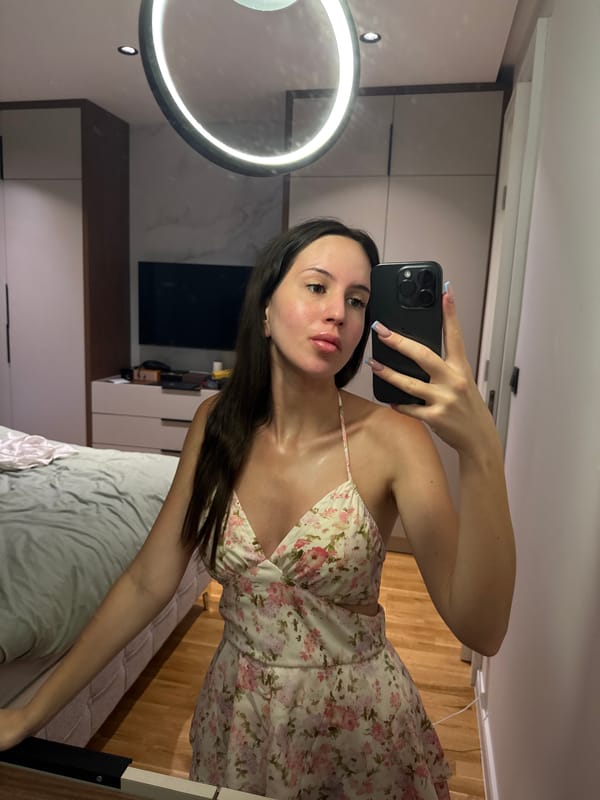 Mirror selfies in a floral dress, bedroom setting