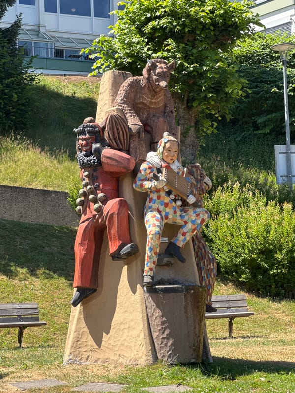 Folk sculpture and historic church in Triberg im Schwarzwald
