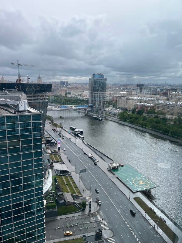 Aerial view captures overcast cityscape with river and helipad