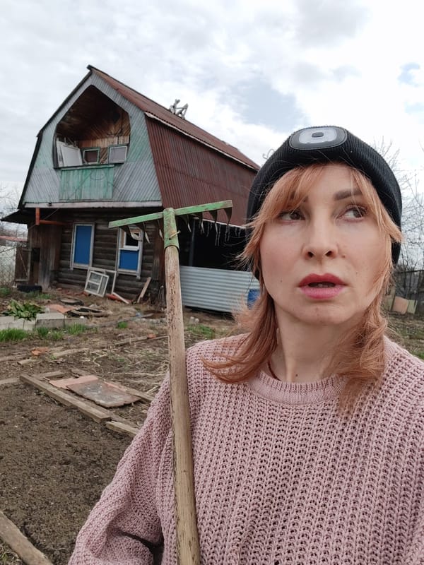 Woman does morning yard work in Chaikovsky, Russia