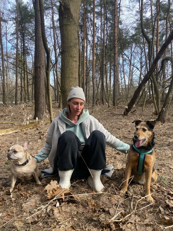 Woman and French bulldog enjoy morning forest outing in Moscow