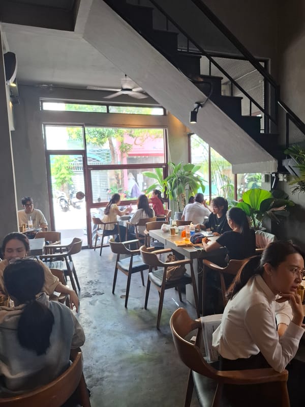 Nha Trang café with green courtyard, iced drinks, and matcha cake
