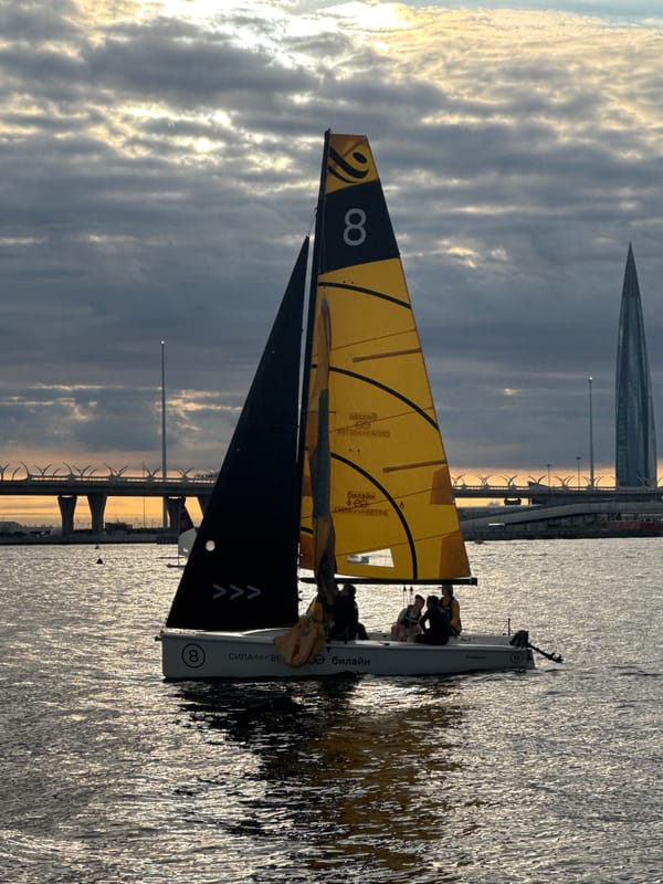 Boats moving along the Neva River on a cloudy evening