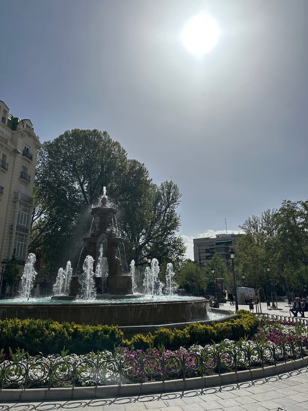 Tiered fountain observed in bright sunlight in Granada, Spain