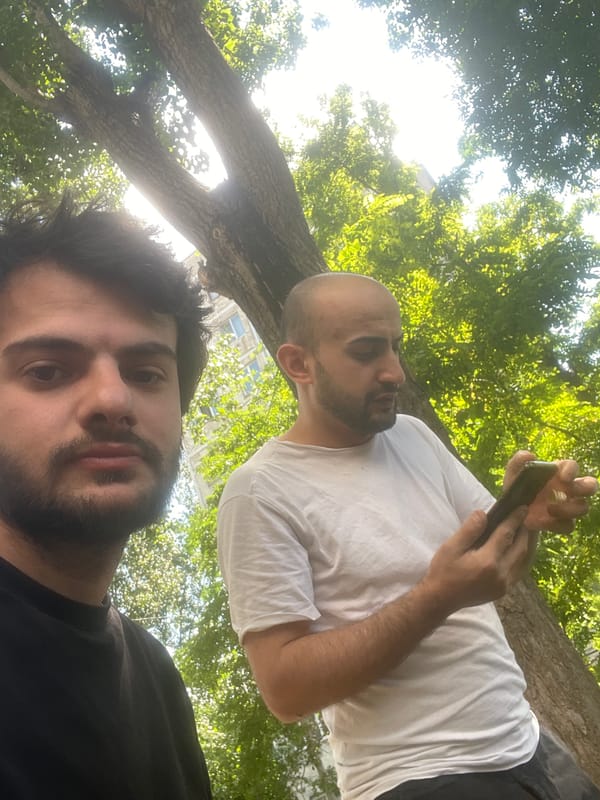 Two men hang out in downtown Tbilisi park area