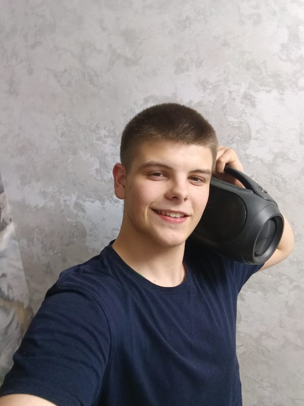 Young man takes selfies with boombox in Andreyevo bedroom