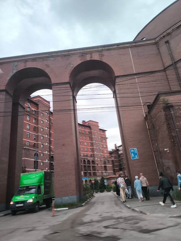 Afternoon scenes around brick buildings and riverside restaurant area