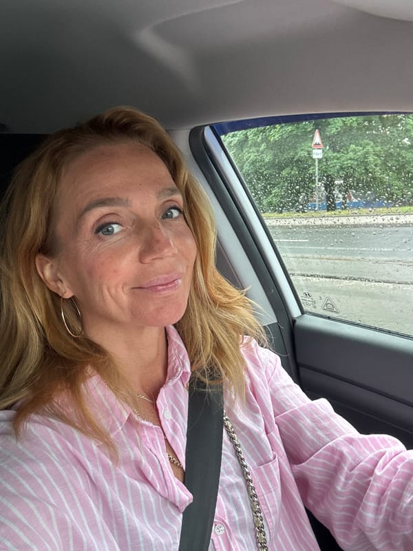 Smiling from the driver's seat on a rainy Saint Petersburg day