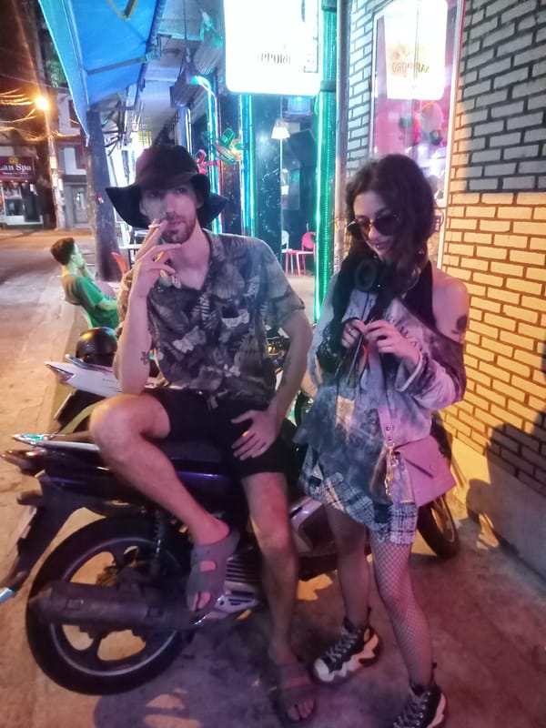 Woman sits in cardboard box on Nha Trang street