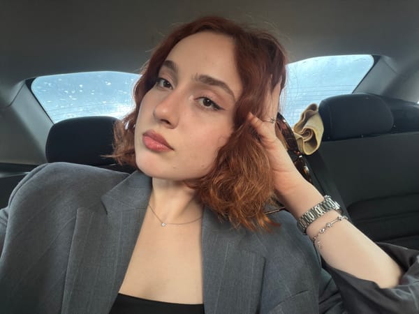 Woman takes playful car selfies during rainy Tbilisi commute