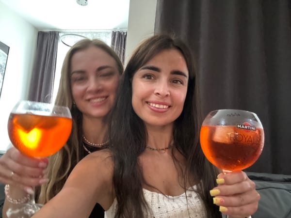 Orange aperitivo drinks and a charcuterie spread at a casual gathering
