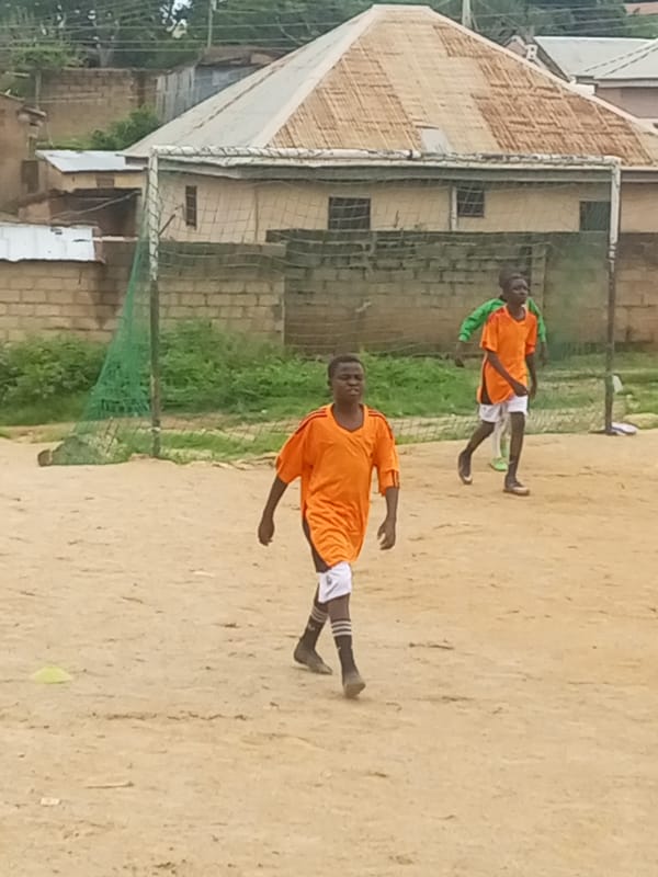 Soccer and rock-side hangouts on a dusty afternoon in Jos