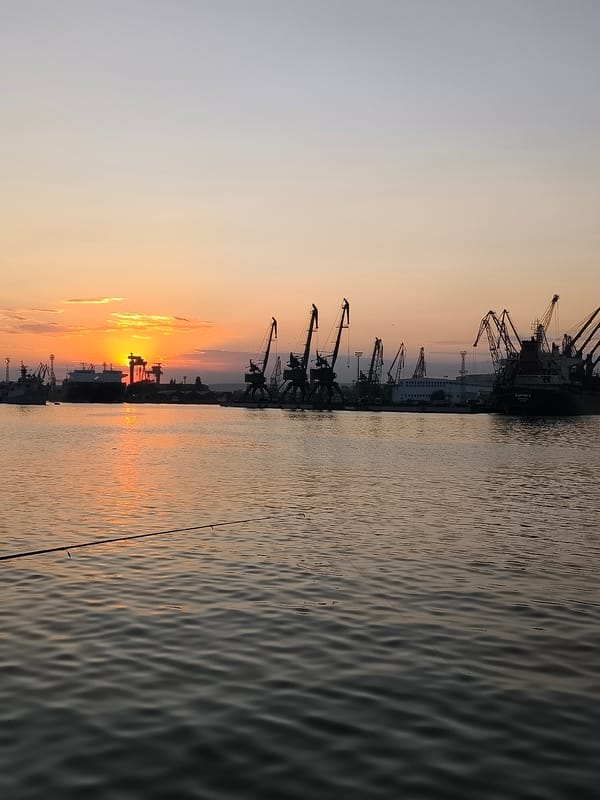 Golden sunset fades over Varna's port skyline