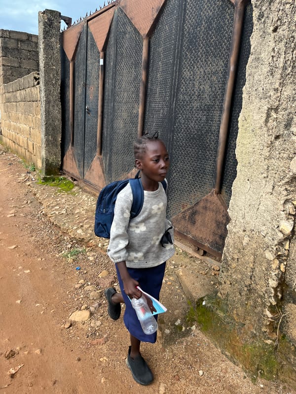 Morning foot traffic on Jos's dirt roads, school day in motion
