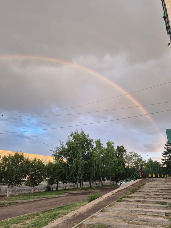 Double rainbow arcs over Kokshetau, Kazakhstan cityscape and mosque