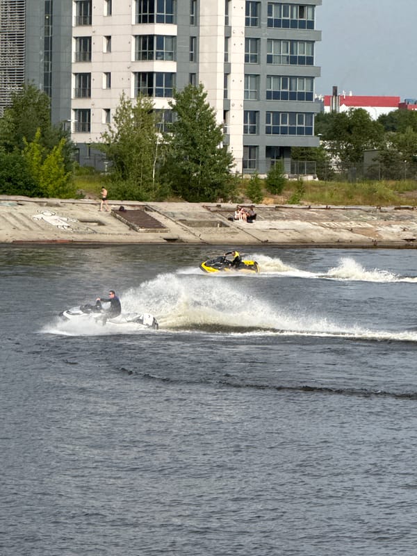 Summer afternoon on Saint Petersburg's waterfront: jet skis and pedestrians