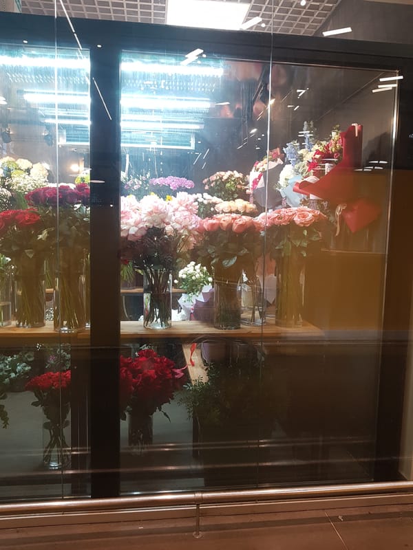 Flower arrangements observed in refrigerated display case in Saint Petersburg