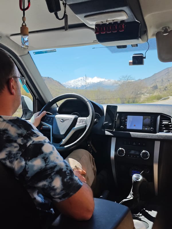Driver travels through mountainous landscape near Bedyk, Russia