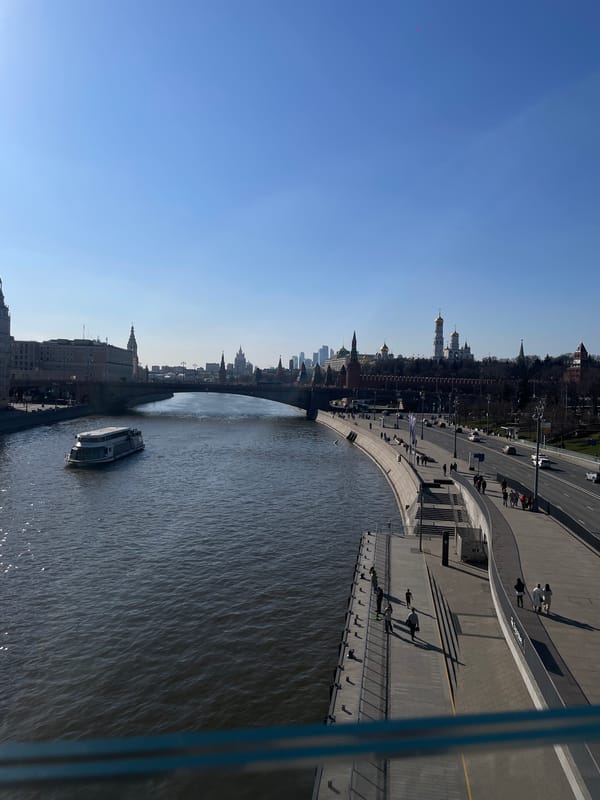 Passenger boat cruises Moskva River past Kremlin in Moscow