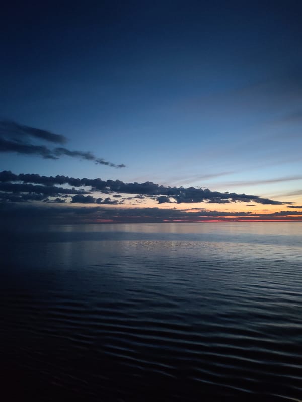 Twilight observed over calm waters at sea