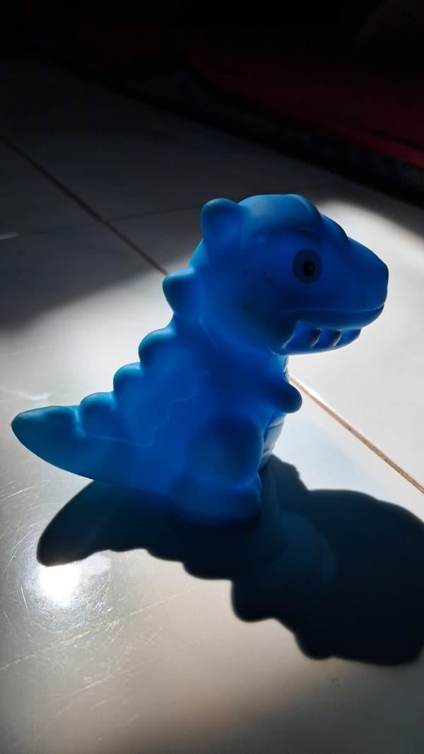 Blue toy dinosaur photographed in Lhokseumawe, Indonesia