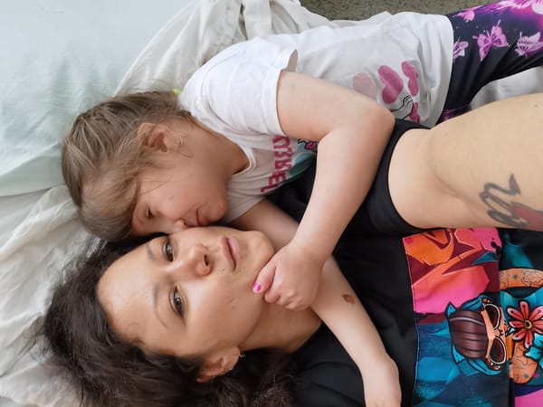 Mother and child share quiet moments on bed in Perm