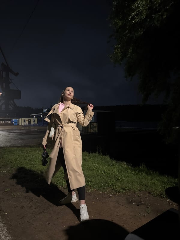 Woman walks through rain-soaked Chaikovsky, Russia on June evening