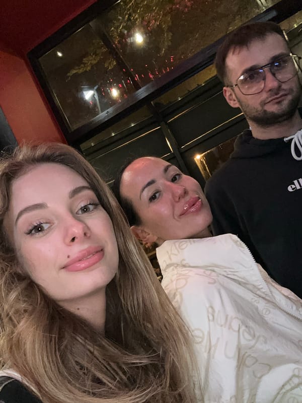 Three people pose for photo in Warsaw indoor gathering
