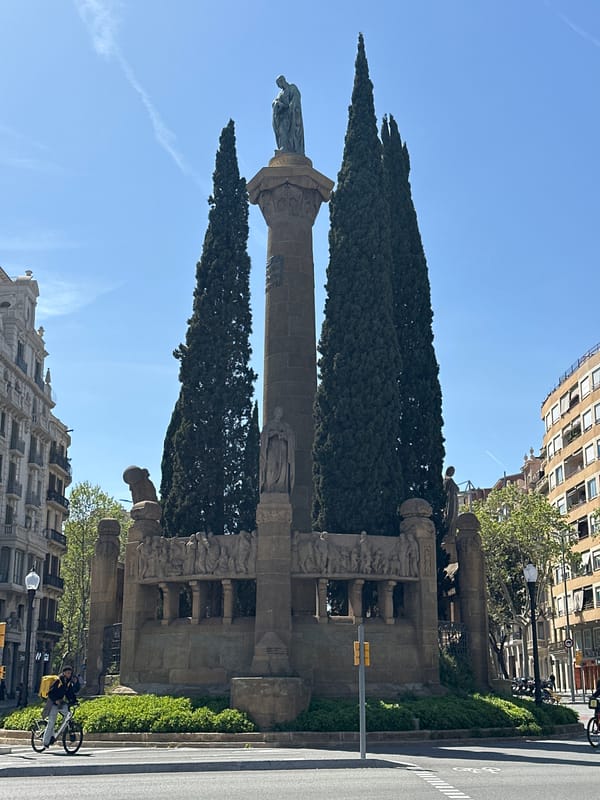 Columbus Monument documented in Barcelona with cypress trees