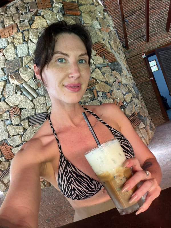 Woman enjoys morning coffee at Vietnamese resort cafe