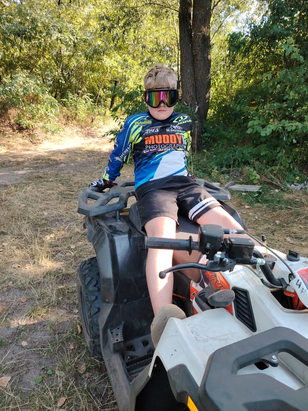 ATV riding through wooded trails near Kyiv on a summer day