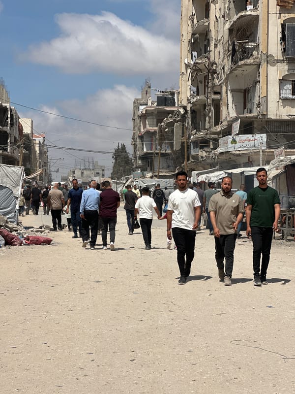 Men walk through war-damaged Gaza City street