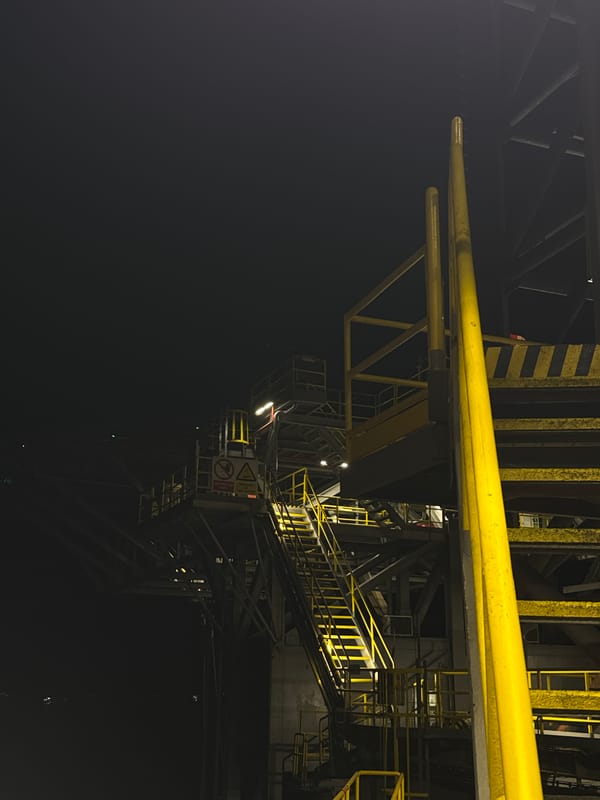 Heavy industrial structure illuminated at night, Italy
