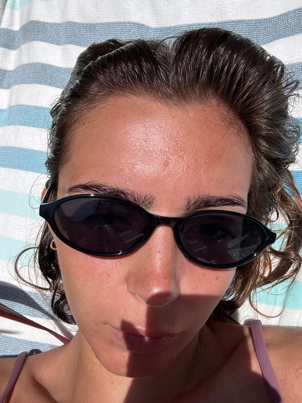 Woman enjoys poolside reading break in Porto area